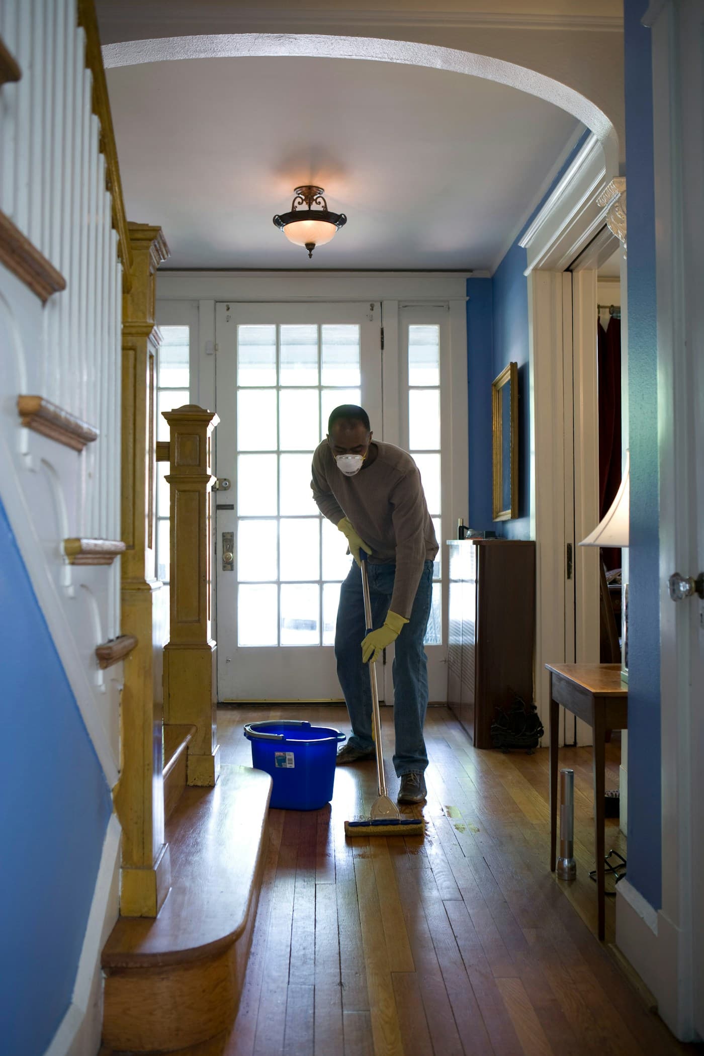 Home cleaner mopping floors during a residential cleaning appointment