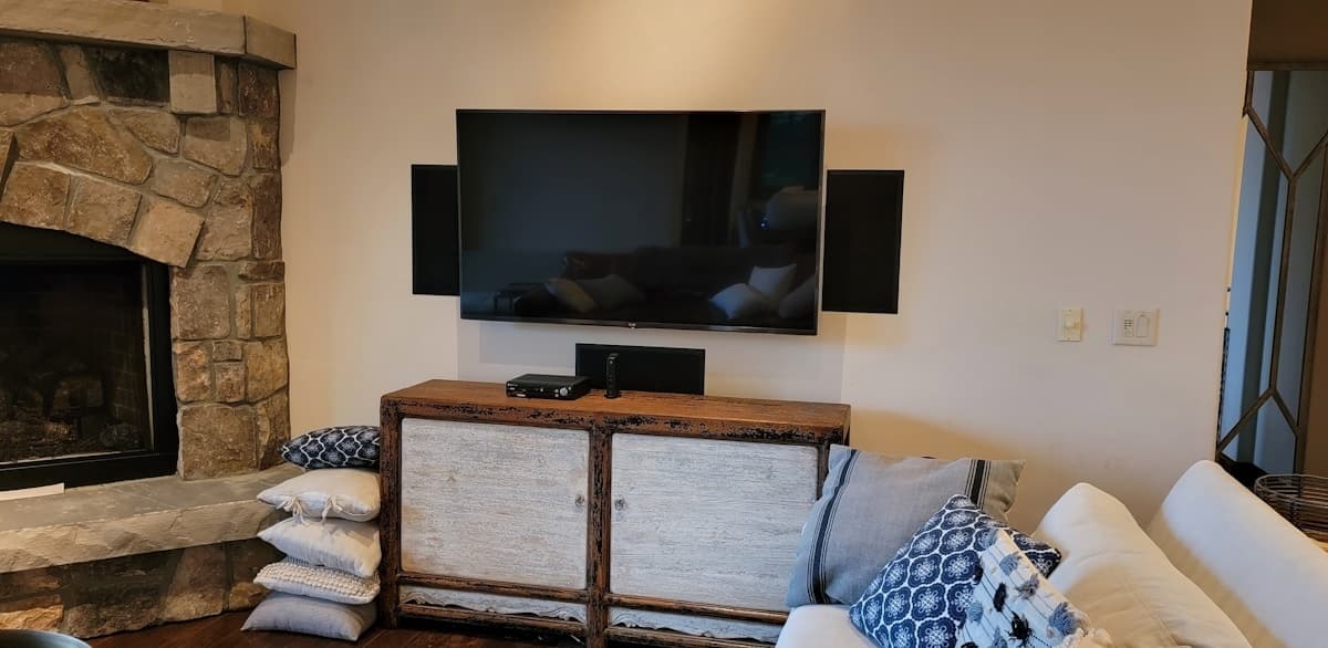 Living room with wall-mounted TV above a fireplace